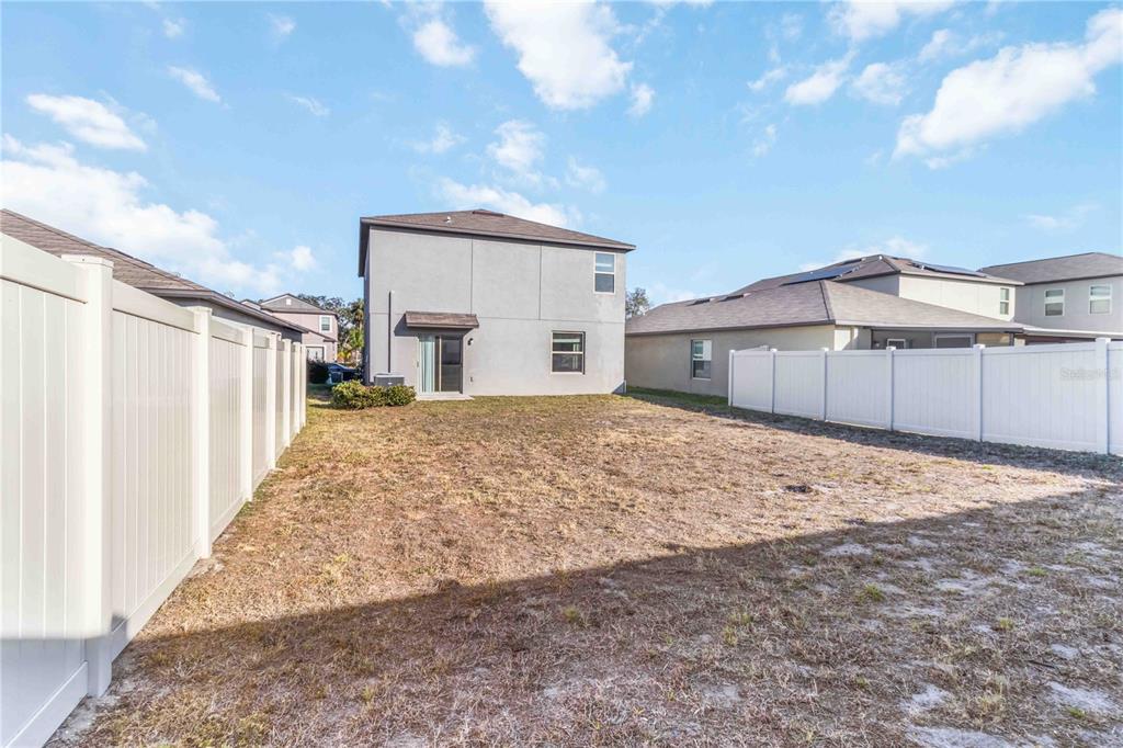 1777 Fred Ives Street Ruskin, FL 33570 - Photo 28 of 35 a view of a backyard with a large tree