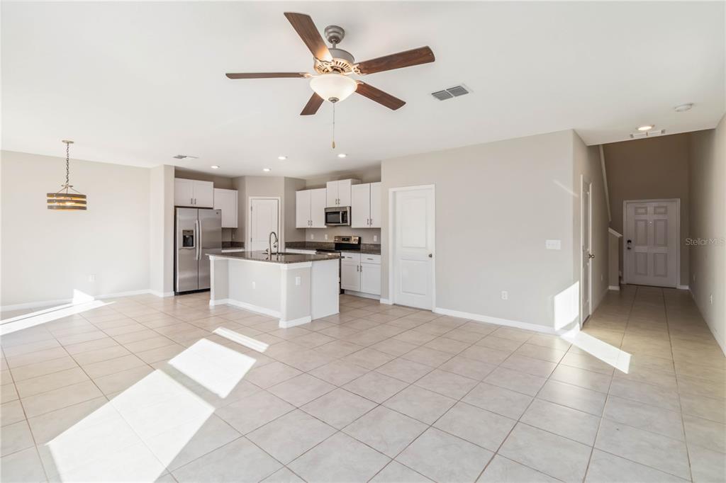 1777 Fred Ives Street Ruskin, FL 33570 - Photo 6 of 35 a view of kitchen with stainless steel appliances refrigerator cabinets and ceiling fan