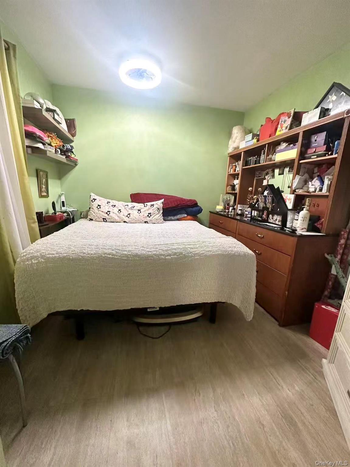 56-22 Van Cleef Street Queens, NY 11368 - Photo 2 of 9 a bedroom with a bed and a dresser