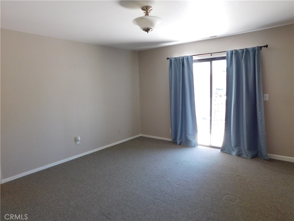 19754 Oak Flat Road Hidden Valley Lake, CA 95467 - Photo 10 of 17 Primary bedroom has sliding door onto small deck.