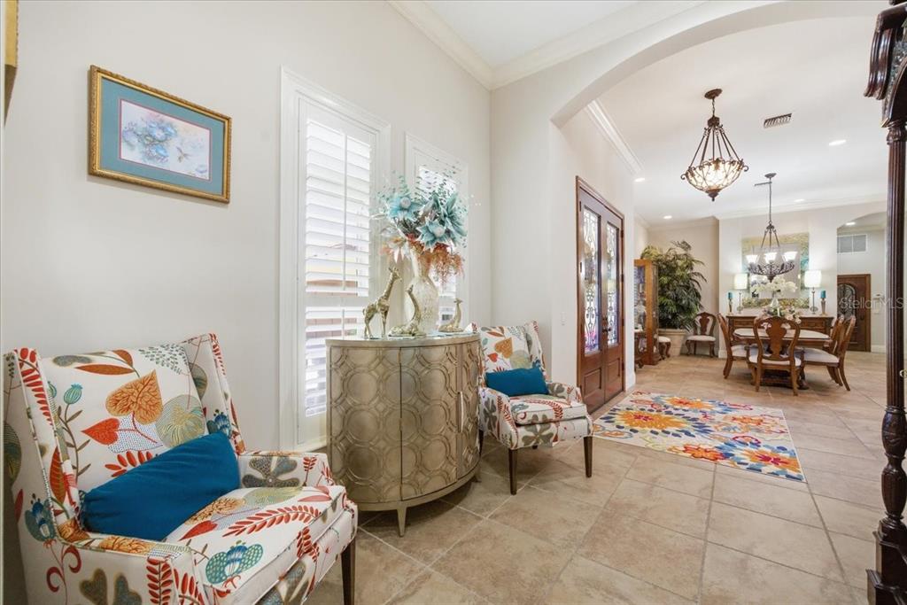 18258 Wayne Road Odessa, FL 33556 - Photo 14 of 100 a living room with furniture and a dining table with chairs