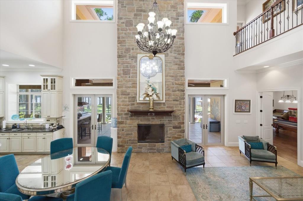 18258 Wayne Road Odessa, FL 33556 - Photo 27 of 100 a living room with fireplace furniture and a chandelier