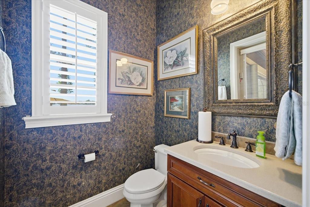 18258 Wayne Road Odessa, FL 33556 - Photo 37 of 100 a bathroom with a sink a toilet and mirror