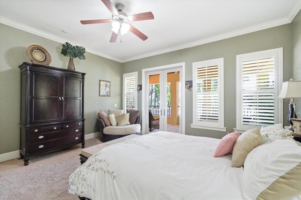 18258 Wayne Road Odessa, FL 33556 - Photo 54 of 100 a bedroom with a bed a window and a chandelier