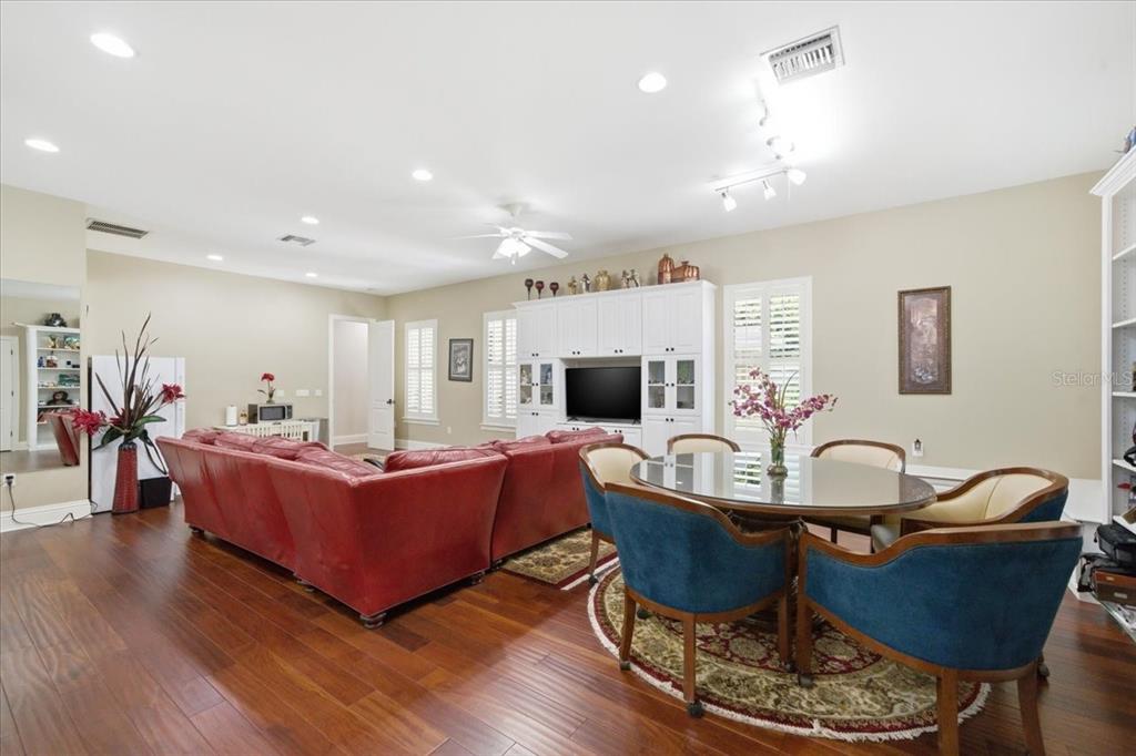18258 Wayne Road Odessa, FL 33556 - Photo 67 of 100 a living room with furniture a flat screen tv and kitchen view