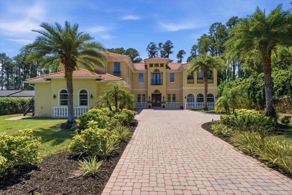 18258 Wayne Road Odessa, FL 33556 - Photo 8 of 100 a front view of a house with a yard and potted plants