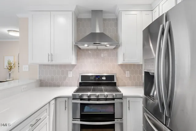 a kitchen with a refrigerator sink and white cabinets