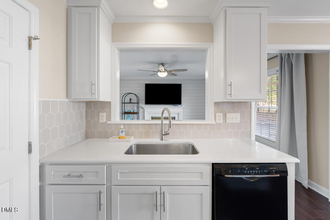 405 Latta Road Durham, NC 27712 - Photo 14 of 43 a sink with cabinets and window