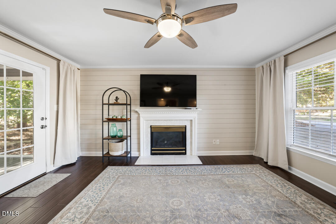 405 Latta Road Durham, NC 27712 - Photo 15 of 43 a living room with furniture a flat screen tv and a fireplace