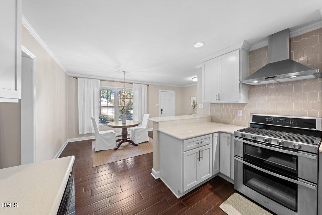405 Latta Road Durham, NC 27712 - Photo 17 of 43 a kitchen with a stove a sink and a refrigerator