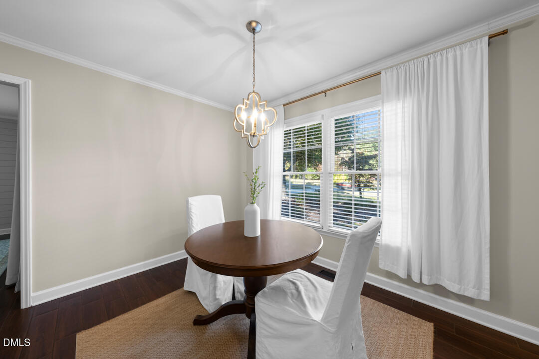 405 Latta Road Durham, NC 27712 - Photo 18 of 43 a view of a dining room with furniture window and wooden floor