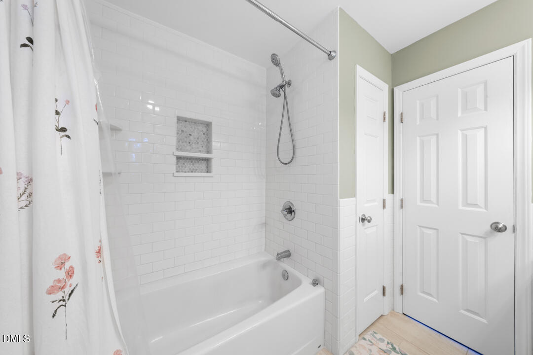 405 Latta Road Durham, NC 27712 - Photo 23 of 43 a bathroom with a bathtub and a shower