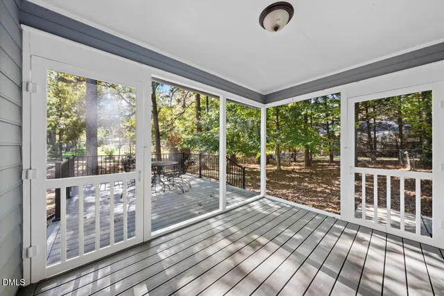 a view of backyard with deck and wooden floor