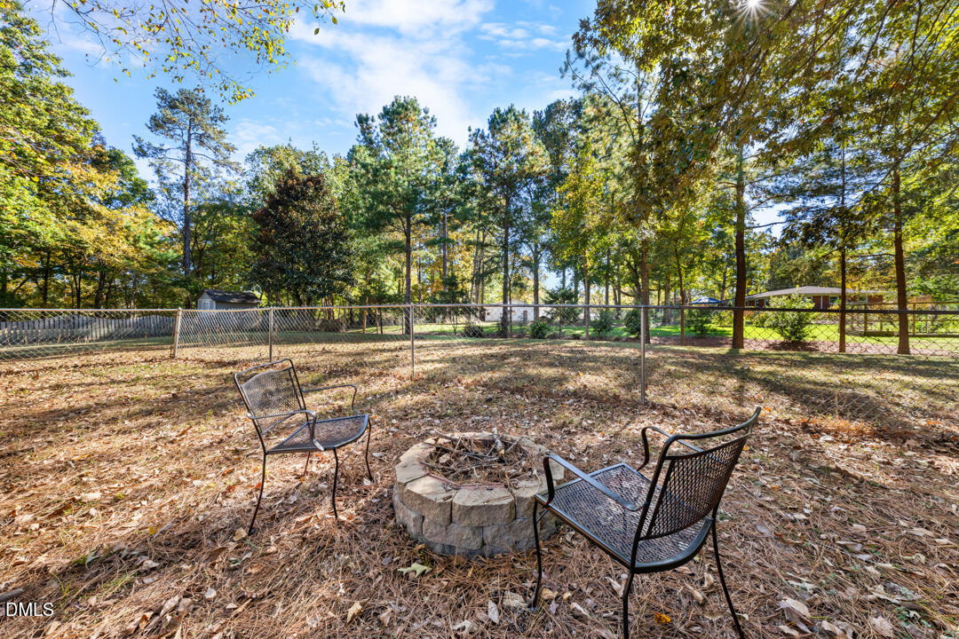 405 Latta Road Durham, NC 27712 - Photo 8 of 43 a view of a yard with wooden bench and trees