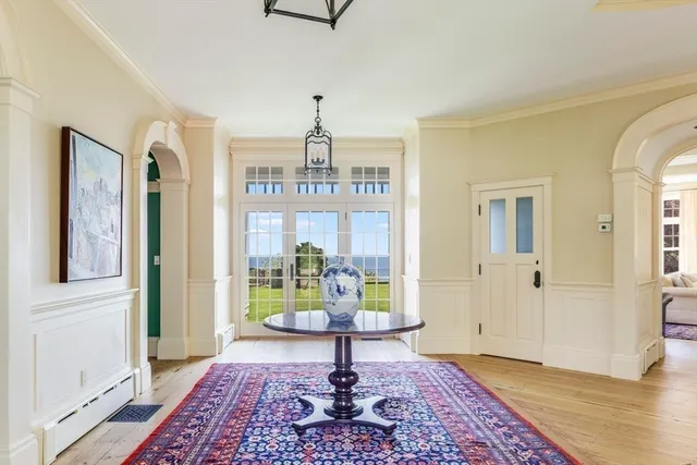 a view of entryway and hall with wooden floor