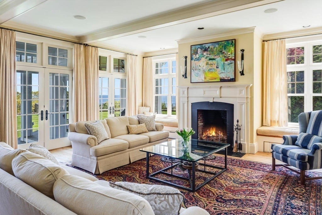 239 Summer Street Manchester, MA 01944 - Photo 20 of 42 a living room with furniture and a fireplace