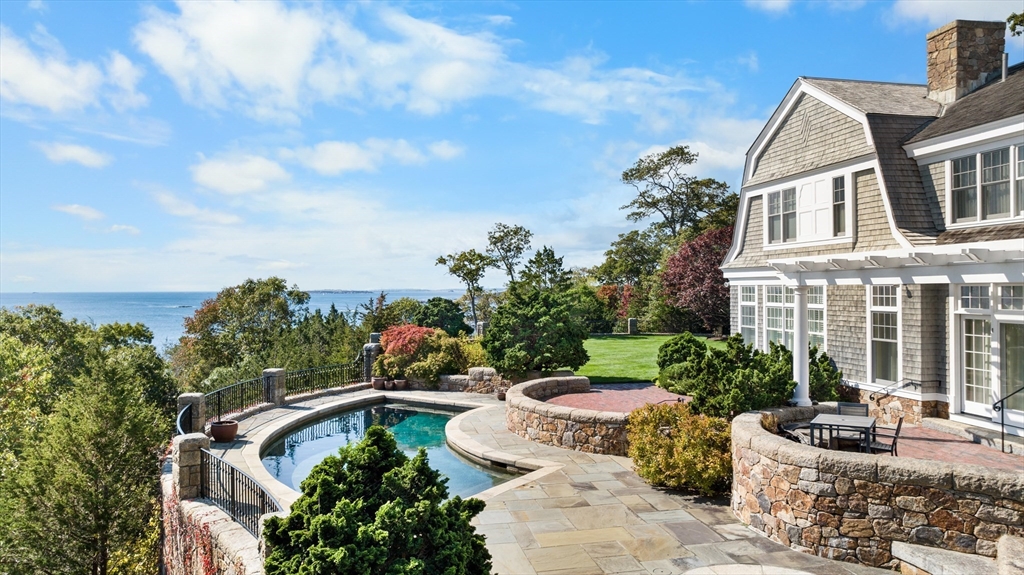 239 Summer Street Manchester, MA 01944 - Photo 2 of 42 a view of a patio with couches table and chairs and potted plants