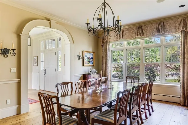 a living room with furniture and floor to ceiling windows