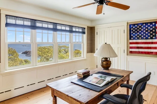 a living room with furniture a fireplace and a large window