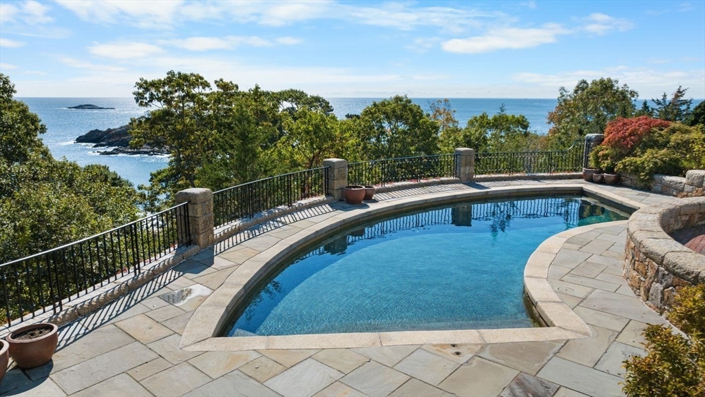 239 Summer Street Manchester, MA 01944 - Photo 3 of 42 a view of a swimming pool with a lounge chair