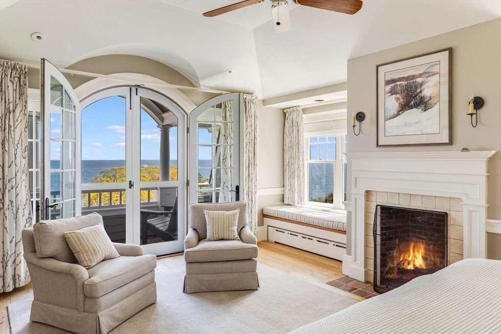 239 Summer Street Manchester, MA 01944 - Photo 31 of 42 a living room with furniture a fireplace and a large window
