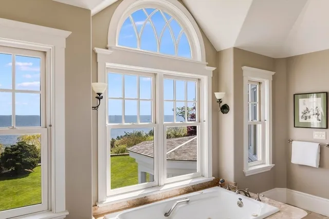 a bathroom with a tub sink and mirror