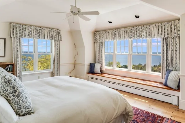 a bedroom with a large bed and a large window