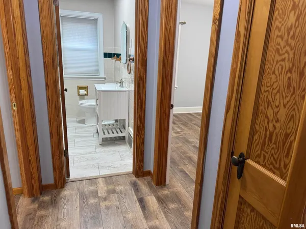 a view of a bathroom from a corridor