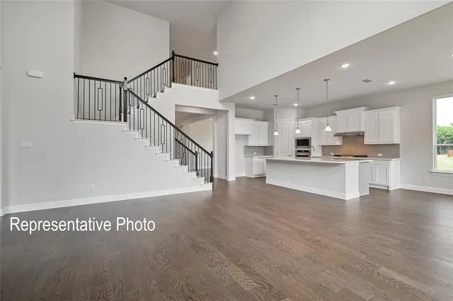 a view of kitchen with wooden floor and electronic appliances