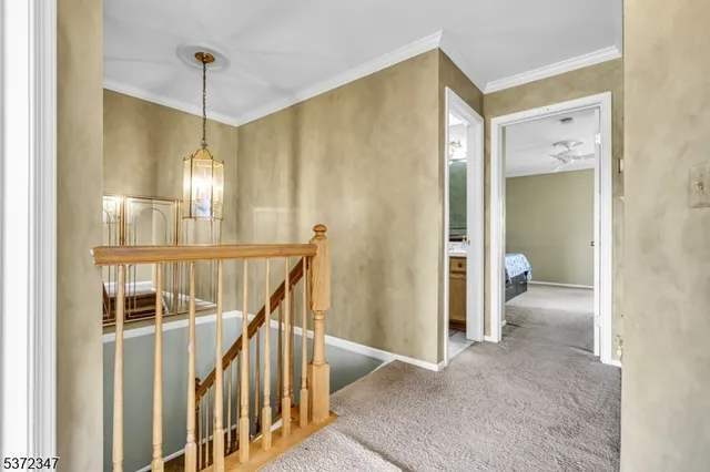a view of a hallway with wooden floor and entryway