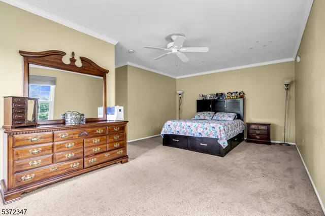 a bedroom with a bed and dresser with mirror