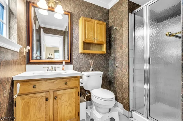 a bathroom with a granite countertop toilet sink and mirror
