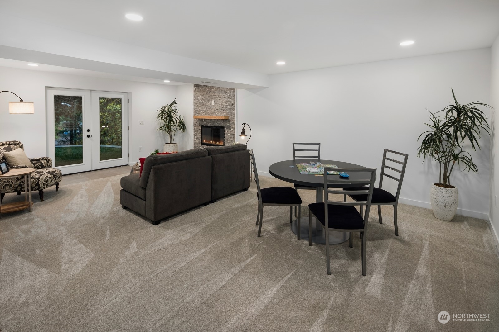 233 Poppy Road Bothell, WA 98012 - Photo 16 of 36 a living room with furniture a dining table and a potted plant