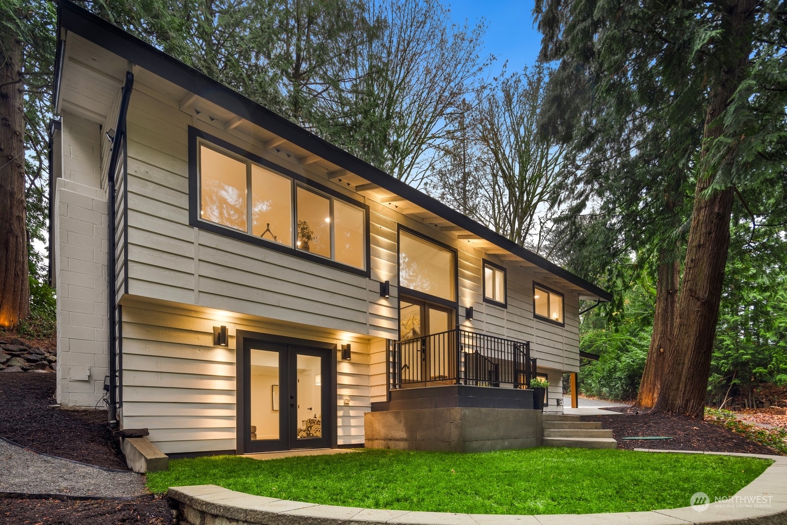 233 Poppy Road Bothell, WA 98012 - Photo 32 of 36 a front view of a house with a garden and plants