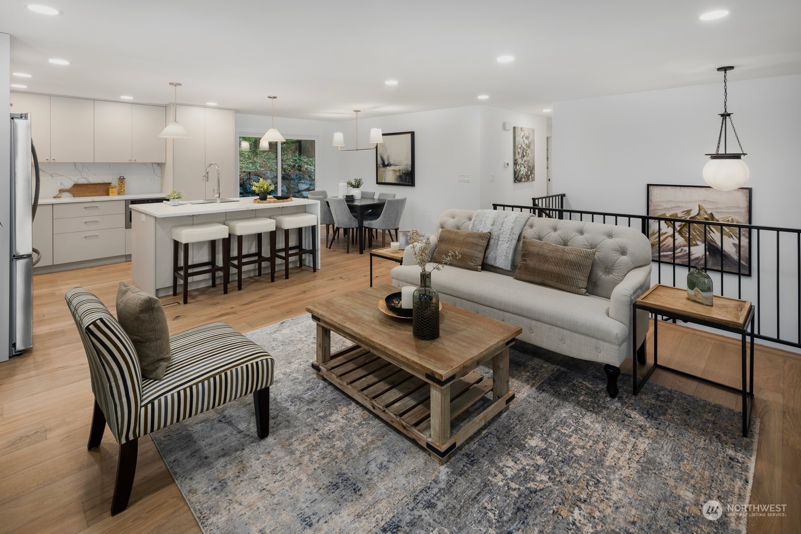 233 Poppy Road Bothell, WA 98012 - Photo 5 of 36 a living room with furniture and a dining table with kitchen view