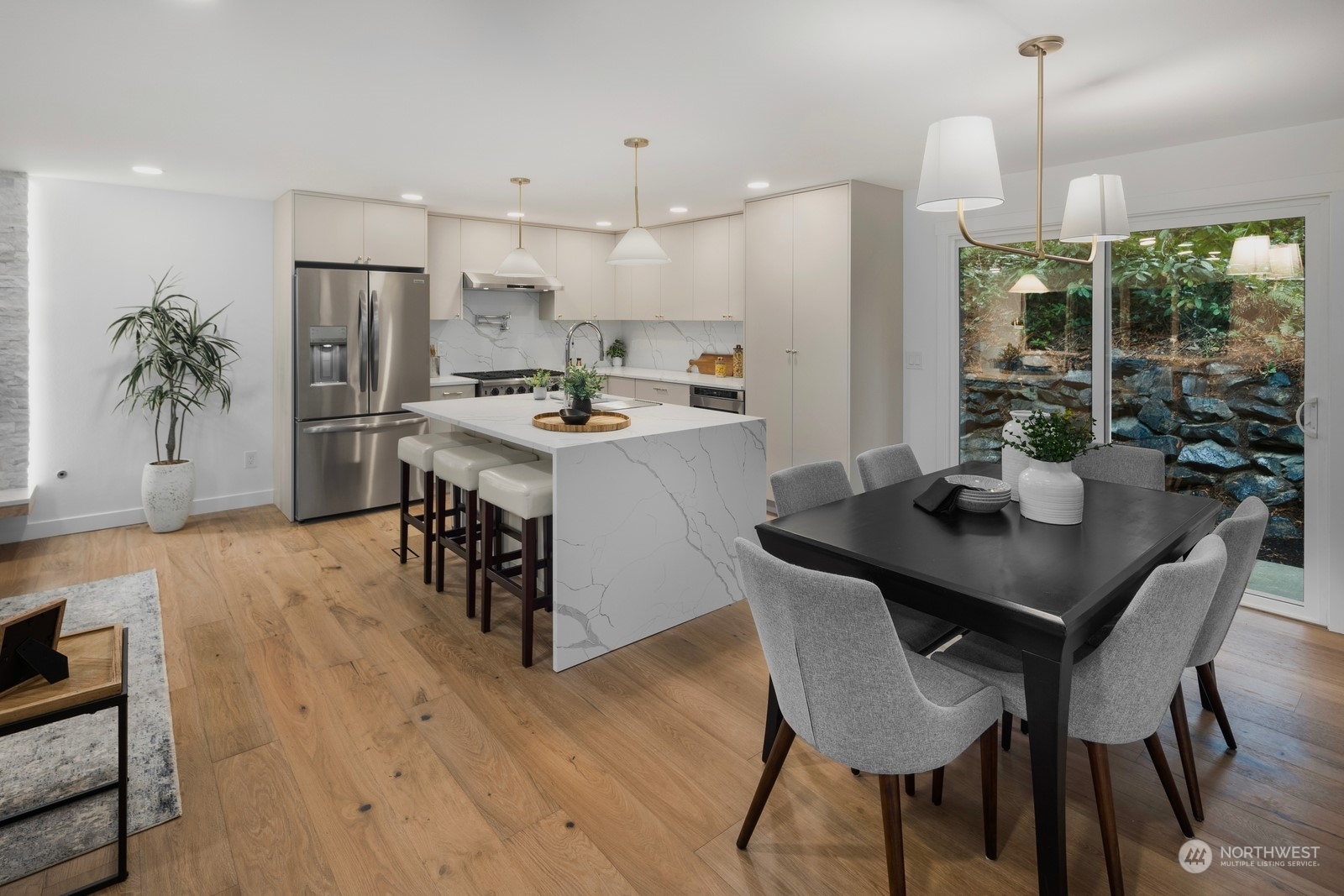 233 Poppy Road Bothell, WA 98012 - Photo 9 of 36 a kitchen with a dining table chairs stainless steel appliances and cabinets