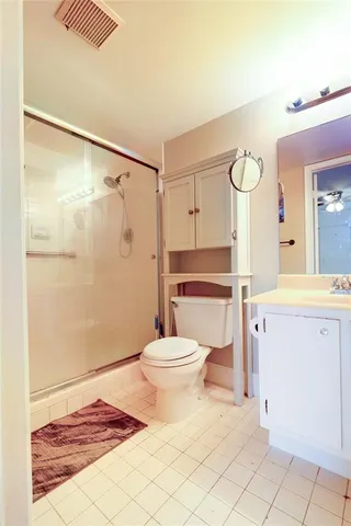 a white toilet sitting next to a bathroom sink