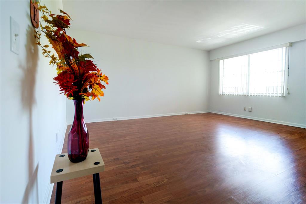 300 Southwest 134th Way, Unit 402E Pembroke Pines, FL 33027 - Photo 2 of 46 a room with lots of flowers and wooden floor