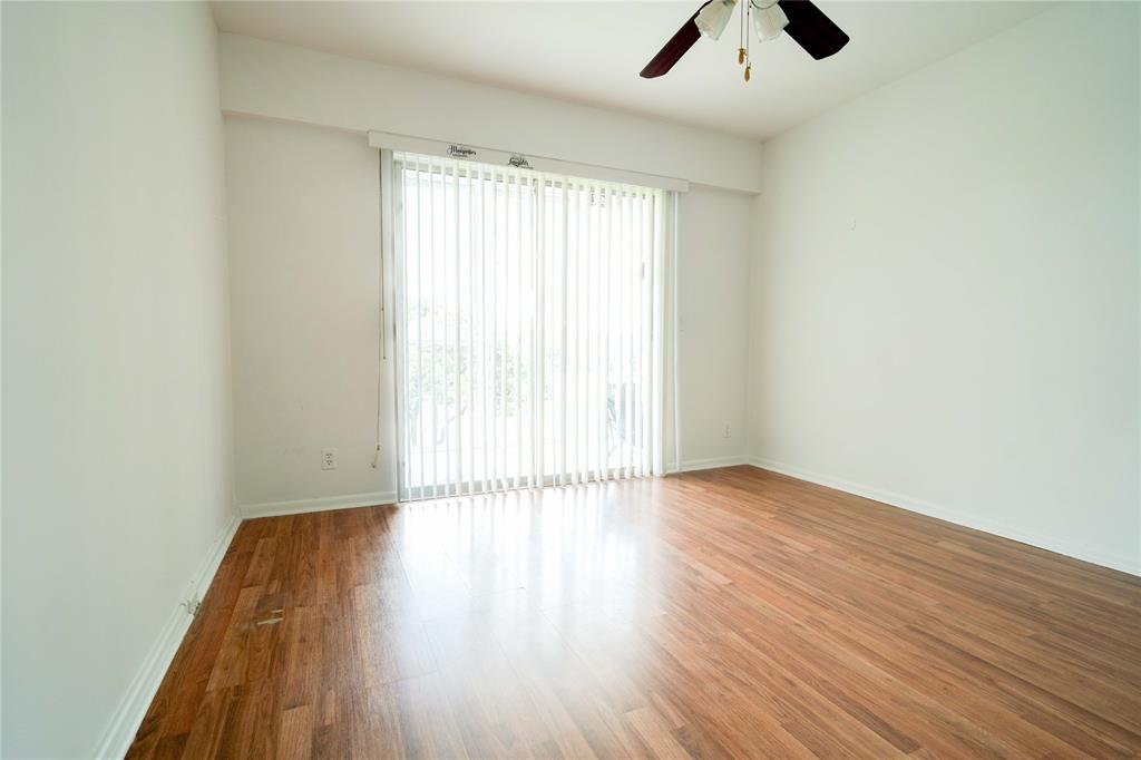 300 Southwest 134th Way, Unit 402E Pembroke Pines, FL 33027 - Photo 22 of 46 an empty room with wooden floor and windows