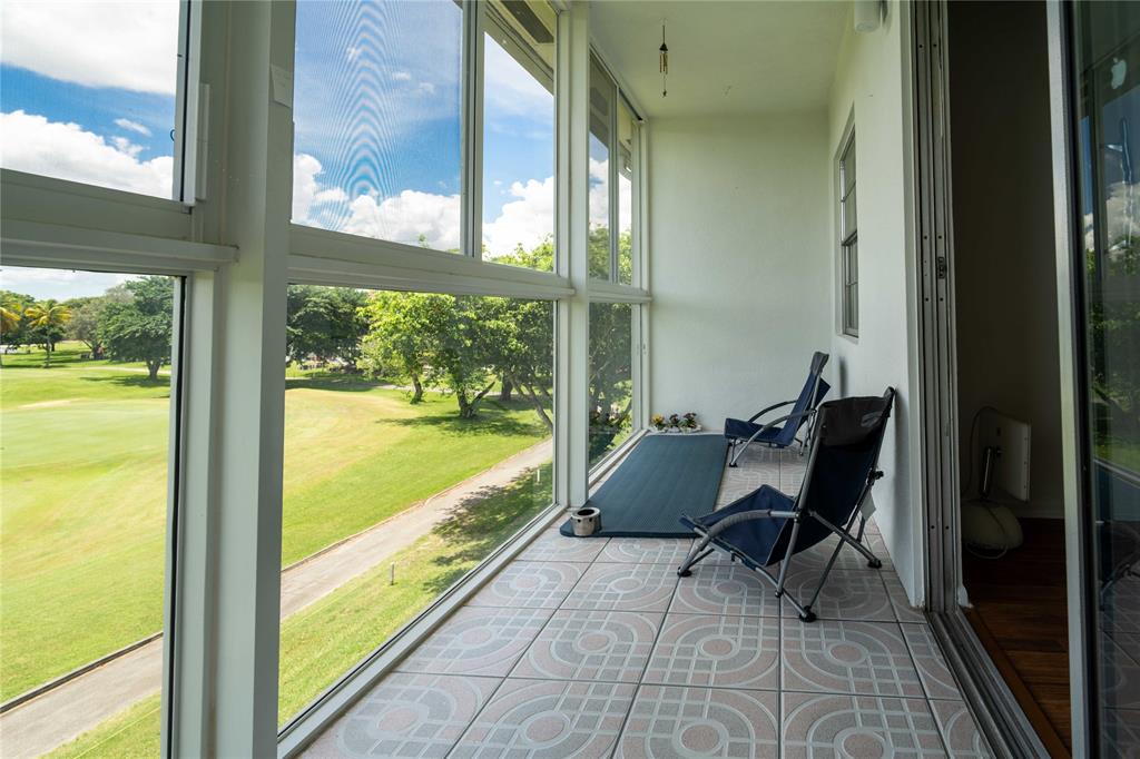 300 Southwest 134th Way, Unit 402E Pembroke Pines, FL 33027 - Photo 26 of 46 a view of a dining room with furniture and floor to ceiling window