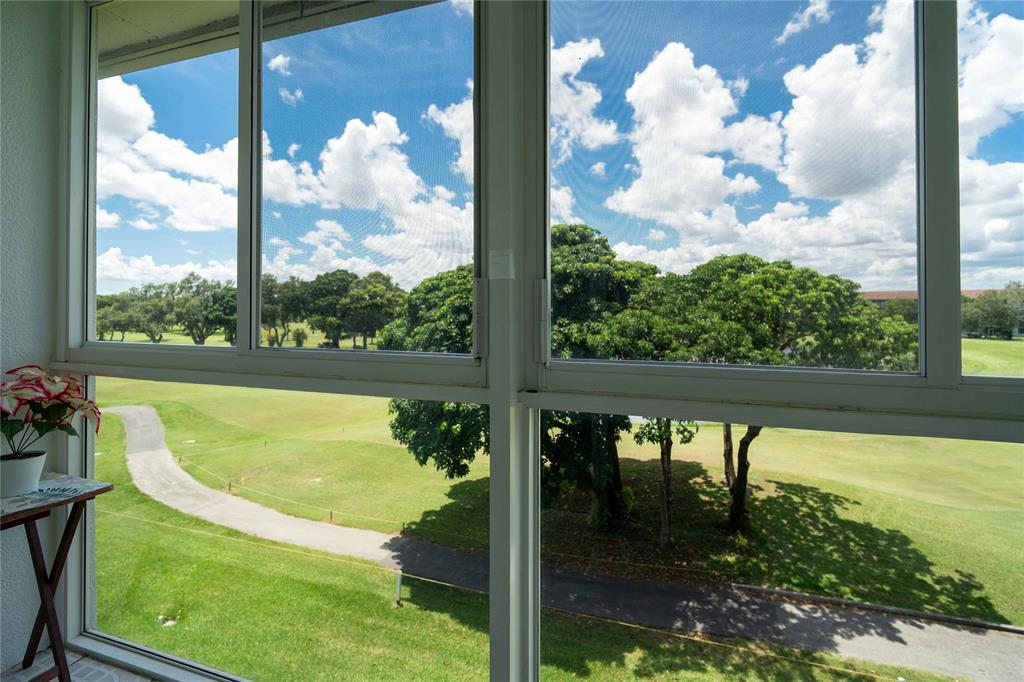 300 Southwest 134th Way, Unit 402E Pembroke Pines, FL 33027 - Photo 27 of 46 a view of swimming pool from a window