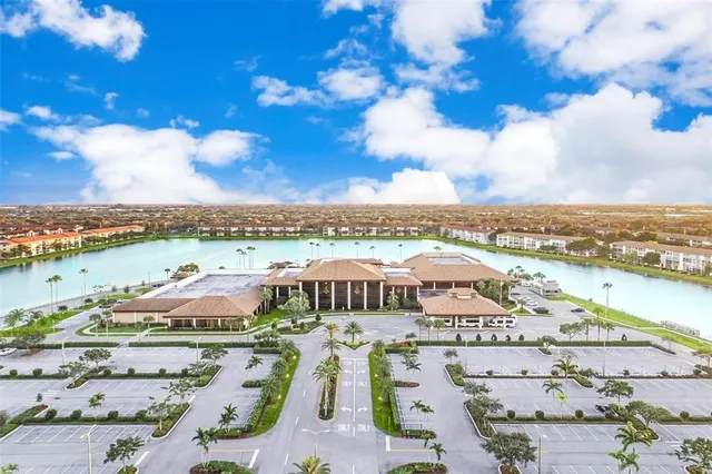 an aerial view of residential houses with outdoor space and trees