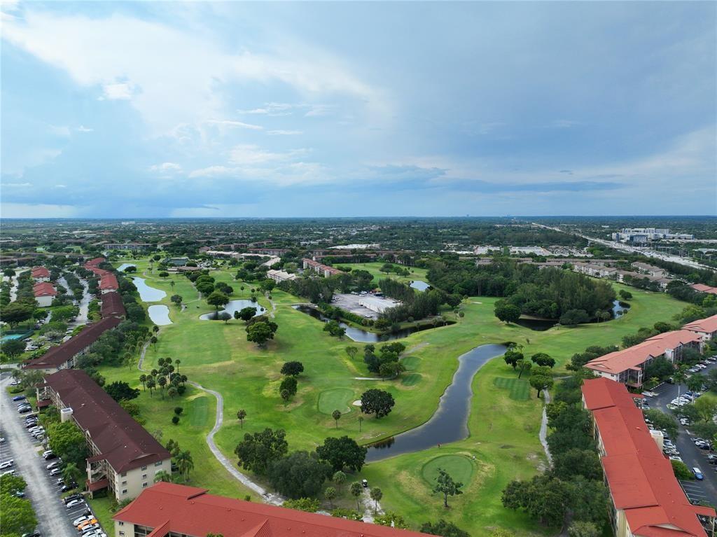 300 Southwest 134th Way, Unit 402E Pembroke Pines, FL 33027 - Photo 37 of 46 an aerial view of residential houses with outdoor space and trees