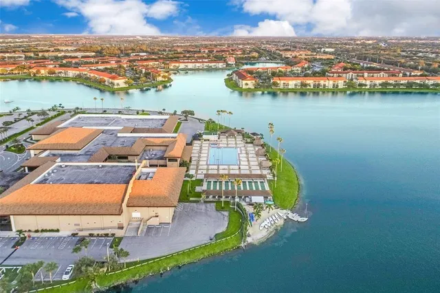 an aerial view of a house with a swimming pool yard and lake view