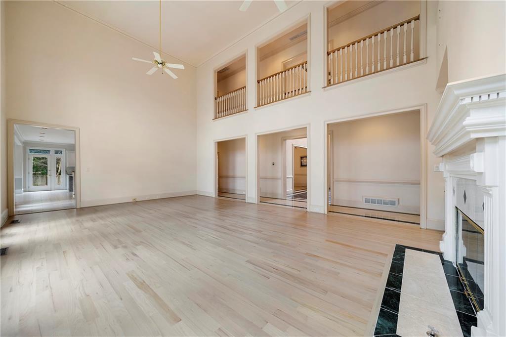 5360 Northwater Way Duluth, GA 30097 - Photo 11 of 62 wooden floor in an empty room with a fireplace