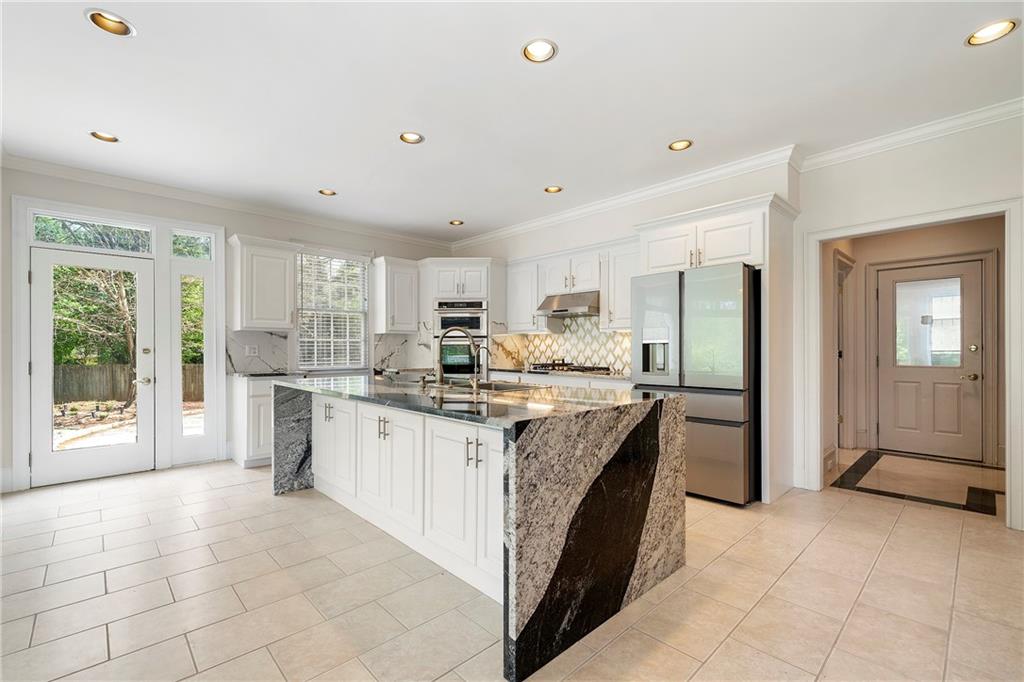 5360 Northwater Way Duluth, GA 30097 - Photo 12 of 62 a kitchen with stainless steel appliances granite countertop a stove oven and a refrigerator