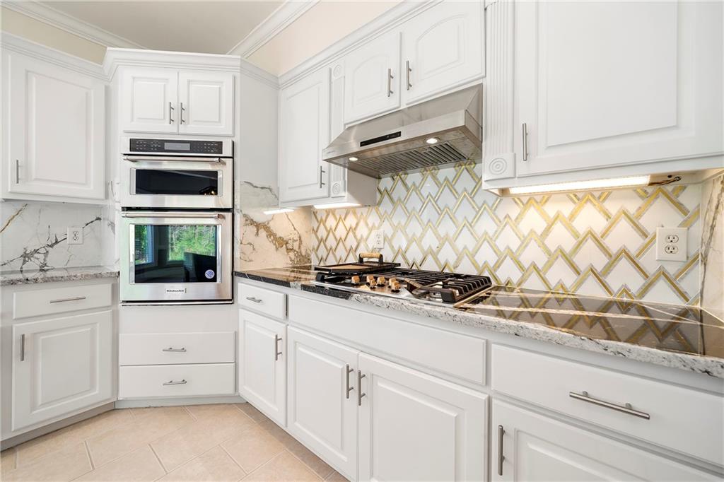 5360 Northwater Way Duluth, GA 30097 - Photo 13 of 62 a kitchen with white cabinets and appliances