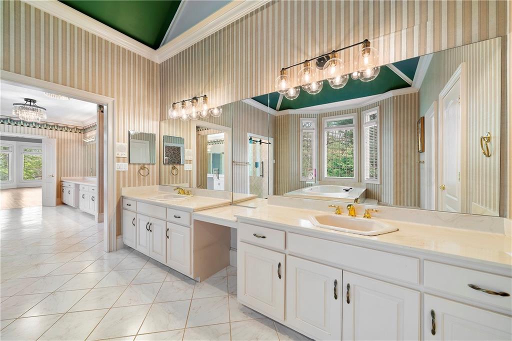 5360 Northwater Way Duluth, GA 30097 - Photo 23 of 62 a bathroom with a sink and a large mirror