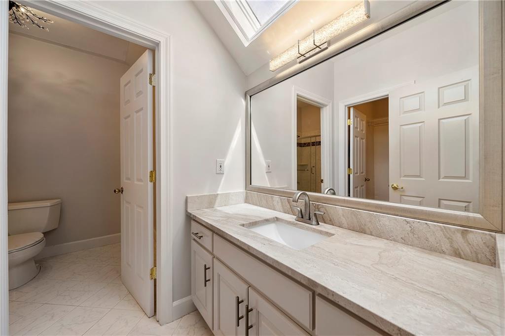5360 Northwater Way Duluth, GA 30097 - Photo 30 of 62 a bathroom with a granite countertop sink and a mirror