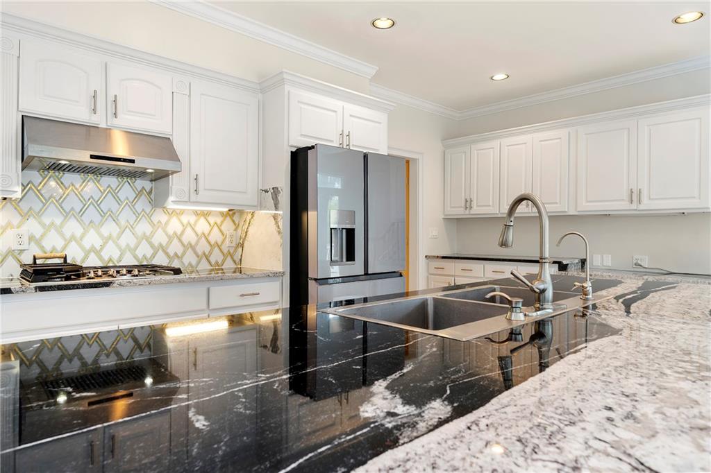 5360 Northwater Way Duluth, GA 30097 - Photo 3 of 62 a kitchen with stainless steel appliances granite countertop a sink stove and refrigerator